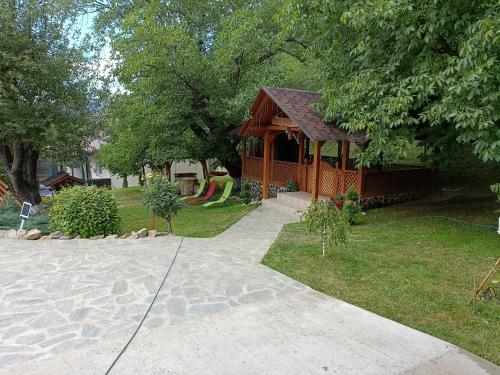 a small building with a playground in a park at CASA DINTRE PINI in Păltinoasa