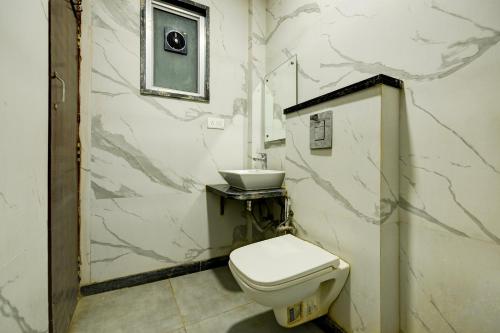 a bathroom with a toilet and a sink at Hotel Star Paradise in New Delhi