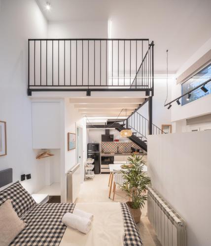 a loft conversion with a staircase and a living room at Apartamentos Bahía&Arena - Centro in Santander
