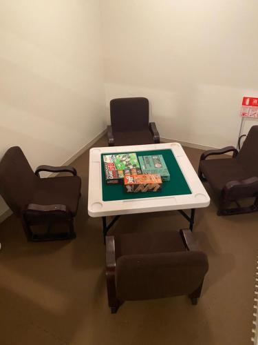 a table in a waiting room with chairs and a table at 貸切別荘カリイ Vacation Rental KALLY Naha Okinawa in Naha