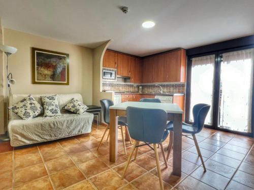 a living room with a table and a couch at Hostal la Colmena in Avila