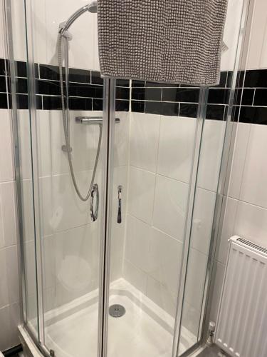 a shower with a glass door in a bathroom at Oldcotes Studio. in Firbeck