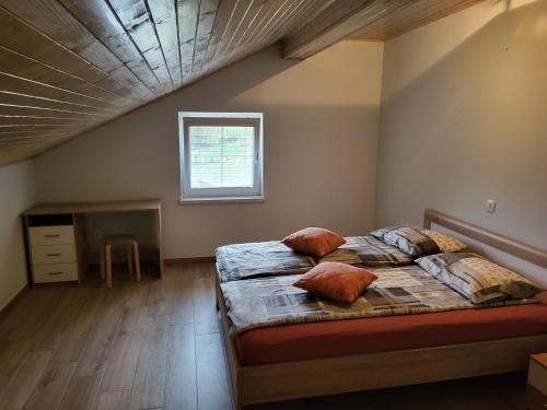a bedroom with two beds and a window at apartma jermol in Most na Soči