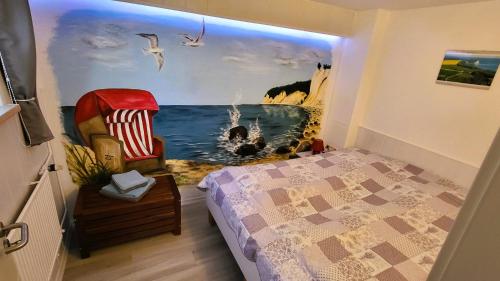 a bedroom with a painting of the ocean at Fewo Gademow in Parchtitz