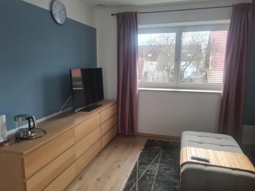 a living room with a tv on a wooden dresser at Anides in Dillingen an der Donau