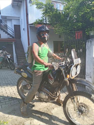 a man is standing on a motorcycle at Villa 95 Rangala in Kandy