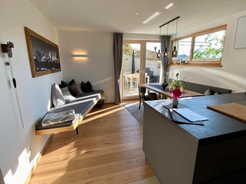 a living room with a couch and a table at s'pölven NEST in Bad Häring