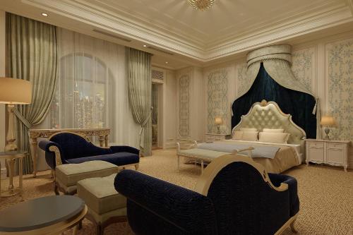 a bedroom with a king sized bed and a living room at The Castle Hotel, a Luxury Collection Hotel, Dalian in Dalian