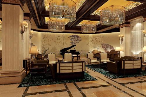 a waiting room with a grand piano and chairs at The Castle Hotel, a Luxury Collection Hotel, Dalian in Dalian