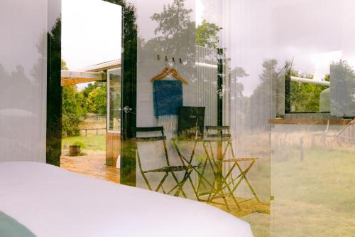 a room with a window with a table and chairs at Rimu View 1 by Tiny Away in Hokitika