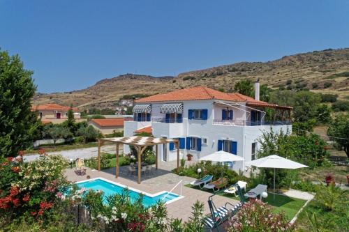 a villa with a swimming pool and a resort at Thalassa Home Comfort in Petra
