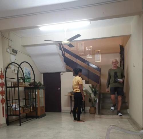 a man and a child standing in a room at Little Cozy Homestay in Kota Bharu