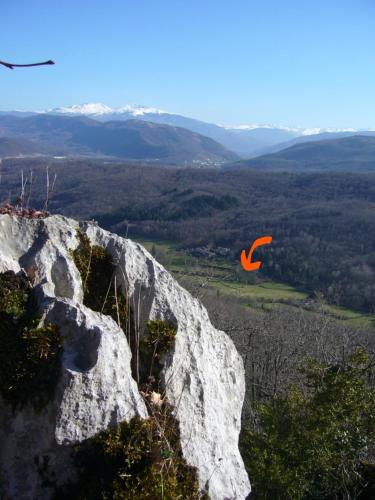 an orange kite is flying over a mountain at Gite de Mailhac in Loubières