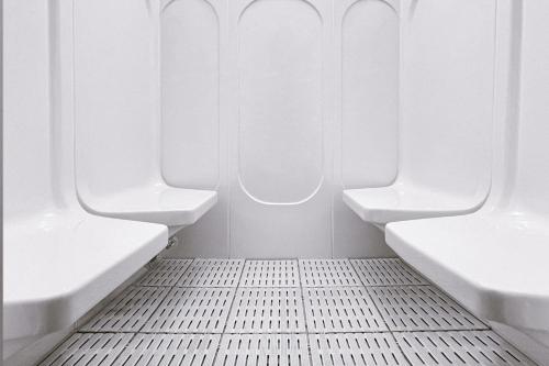 an airplane bathroom with two toilets and a tiled floor at Le Méridien Hong Kong, Cyberport in Hong Kong