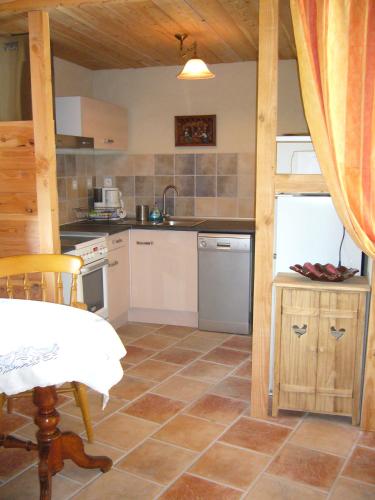 a kitchen with a table and a counter top at Gite de Mailhac in Loubières