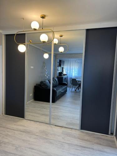 a mirror in a room with a bed and a bedroom at David Apartament’s in Buzău