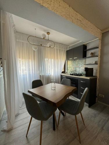 a dining room table and chairs in a kitchen at David Apartament’s in Buzău