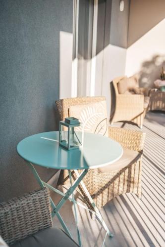 a glass table and chairs on a balcony at "La Terrazza di Via Roma" Delta del Po - Private Parking in Porto Viro
