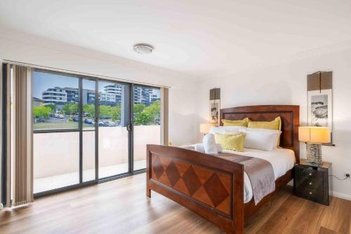 a bedroom with a large bed and a large window at Mountain Waves in Barrack Point