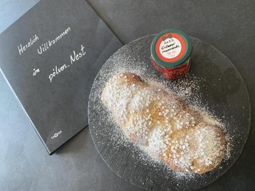 a plate with a doughnut and a jar of jelly at s'pölven NEST in Bad Häring