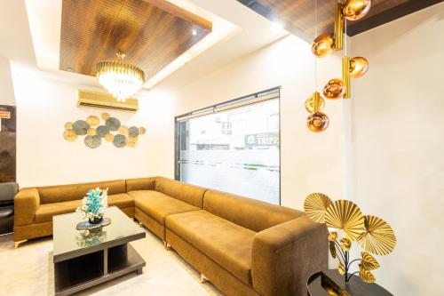 a living room with a couch and a table at Hotel Cosmo Near BLK Hospital Karol Bagh in New Delhi