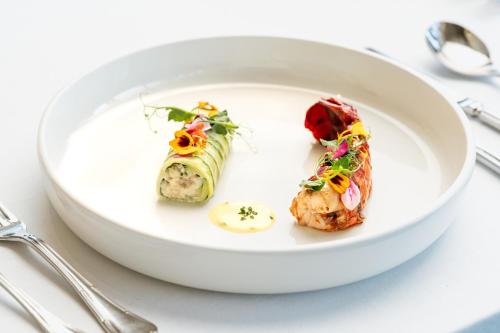 a white plate with food on a table at Makkah Clock Royal Tower, A Fairmont Hotel in Makkah