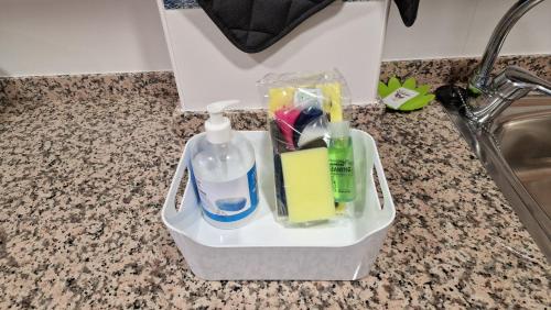 a plastic container with toothbrushes and other bathroom items on a counter at Citadel Oliva 4p Roses, Beach & Centre, Private Parking, Terrace in Roses