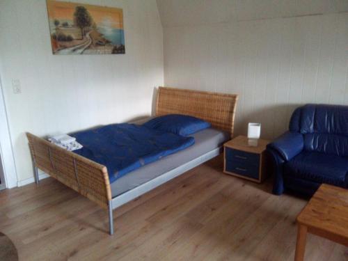 a bedroom with a bed and a chair and a couch at Zum Bothmerschen Krug in Schwarmstedt