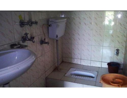 a bathroom with a sink and a toilet at Hotel Chandradeep, Joshimath in Joshīmath