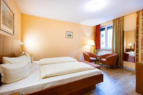 a hotel room with a large bed and a bedroom at Hotel Alter Kranen in Würzburg