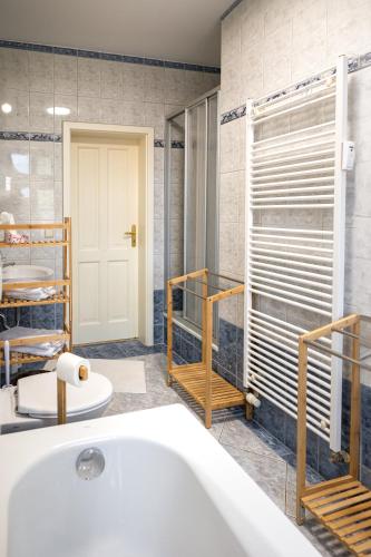 a bathroom with a white tub and a shower at Naumburger Charme St. Barbara in Naumburg