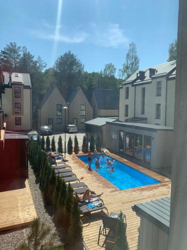 eine Gruppe von Menschen sitzt in einem Schwimmbecken in der Unterkunft Geriausios Atostogos in Palanga