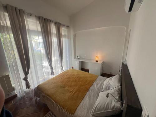 une chambre avec un lit dans une pièce avec des fenêtres dans l'établissement Villa Benji ~ Villa aan de Côte d'Azur, à Puget-sur Argens