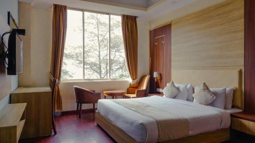 a hotel room with a bed and a window at Sumitel Gangtok Resort in Gangtok