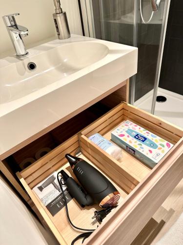 a bathroom with a sink and a drawer with a sink at My Haus European Commision in Brussels