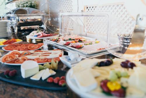 a buffet with many different types of food on display at Hotel Reindl Suiten & Appartments in Bad Füssing