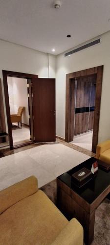 a living room with a couch and a table at Bellevue Park Hotel in Taif