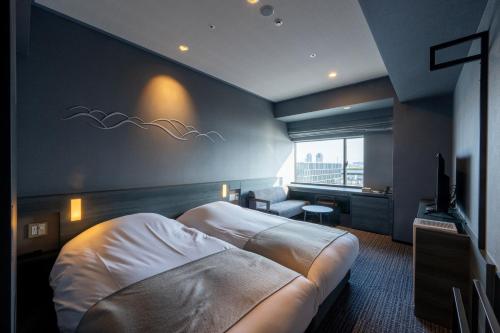 a hotel room with a bed and a television at La Vista Tokyo Bay in Tokyo