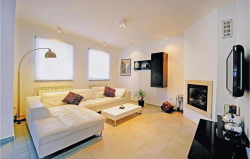 a living room with a white couch and a table at Holiday Home Barban 60 in Barban