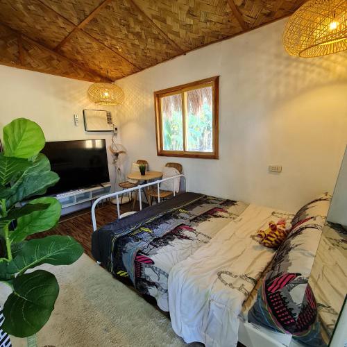 a bedroom with a bed and a flat screen tv at Casa Juan Farm in Candelaria