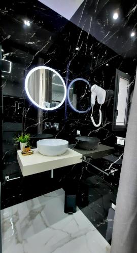a bathroom with a sink and a mirror at Il Canto Di Iside in Marsala