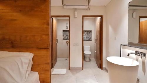a bathroom with a sink and a toilet at DBeds Kuta Beach By Destiny Hospitality in Kuta