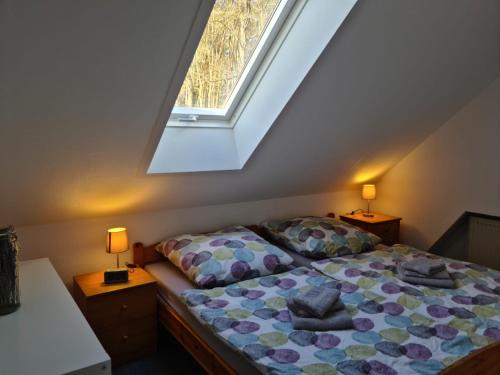 a bedroom with a bed with pillows and a window at Ferienwohnung Prälank direkt am See in Neustrelitz