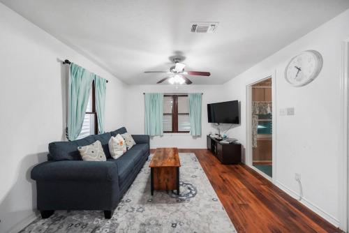 a living room with a couch and a table at Galveston Beach House Family/Pet Friendly in Galveston