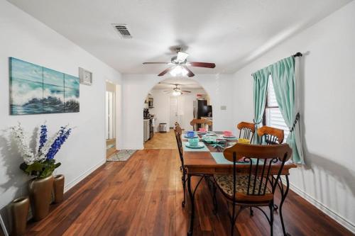 a dining room with a table and a ceiling fan at Galveston Beach House Family/Pet Friendly in Galveston