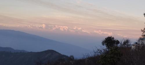 a view of a mountain range in the distance at Ababeel Homestay, Hartola in Rāmgarh