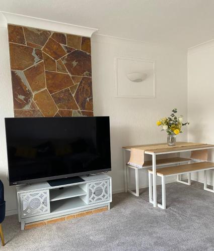 a living room with a large flat screen tv at Spacious 2 Bed Village Flat sleeps 4/6 in Nottingham