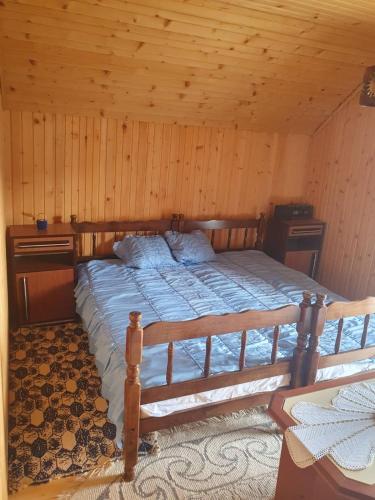 a bedroom with a bed in a wooden room at Nikša apartment in Pljevlja