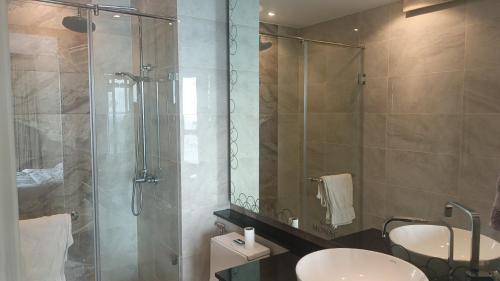 a bathroom with a shower and a toilet and a sink at The Riviera Monaco in Na Jomtien