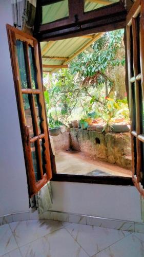 an open window with a view of a garden at Ella bay homestay in Ella
